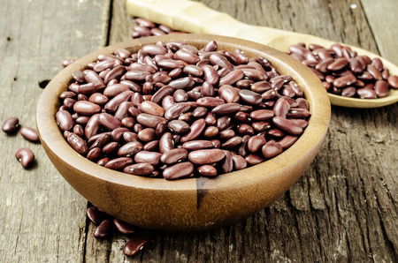 Red beans on wood background in vintage toneの写真素材