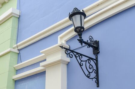 Street lamp mounted on the walls of the building.の写真素材