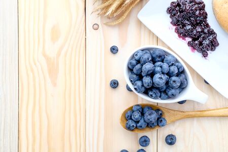 Fresh blueberries and jam on wood backgroundの写真素材