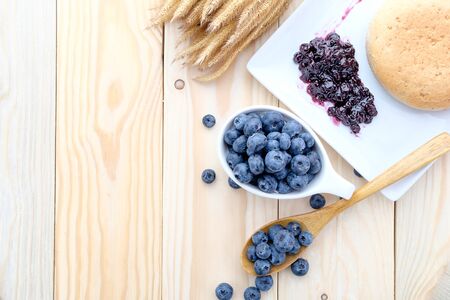 Fresh blueberries and jam on wood backgroundの写真素材