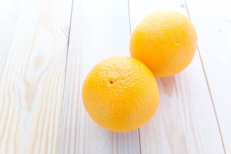 fresh oranges on wood backgroundの写真素材