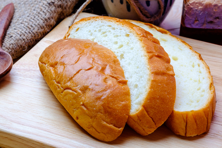 Sliced bread on wooden background.の写真素材