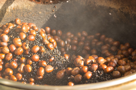 Chestnuts roasted in a large saucepan.の写真素材