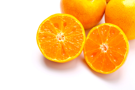 Fresh orange cut in half on a white background.の写真素材