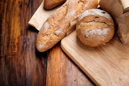 Whole wheat bread on wooden backgroundの写真素材