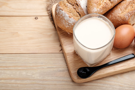 milk and bread on wooden backgroundの写真素材