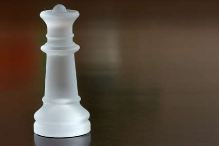 close-up of chess queen on dark brow table topの写真素材