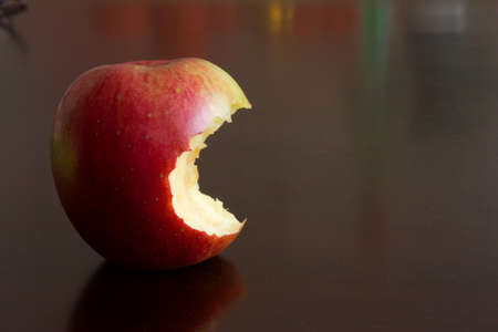 close-up of colorful apple on the dark brown table topの写真素材