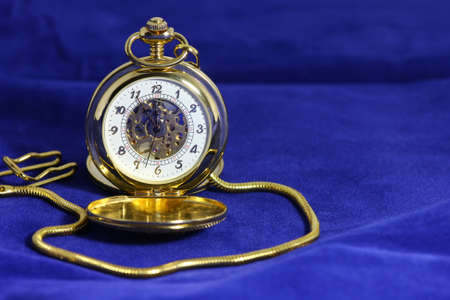 close-up or macro photography of mechanical gold plated pocket watchの写真素材