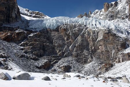 Glacier above dangerous rocky cliff, Himalayasの写真素材