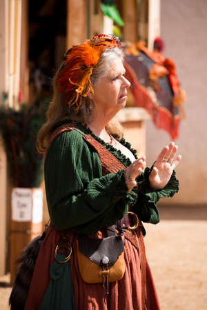 One of many women dressed in period costume at the Renaissance festival in the Phoenix area. Each played a role whether merchant, musician, particpant or visitor.のeditorial素材