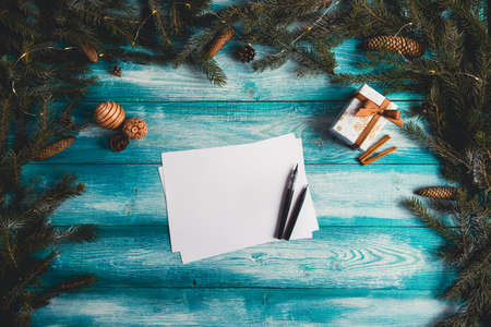 Blank sheet of paper on a blue wooden table with Christmas items. Christmas concept. の写真素材