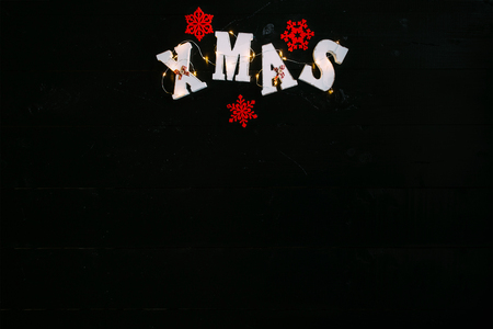 The word Xmas on black wooden background.の写真素材