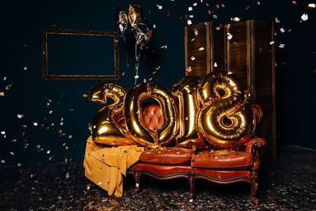 Golden New year air balloons with confetti. Christmas decorationの写真素材