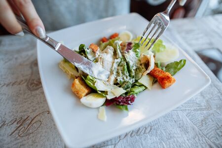 Caesar salad on table in restaurantの写真素材