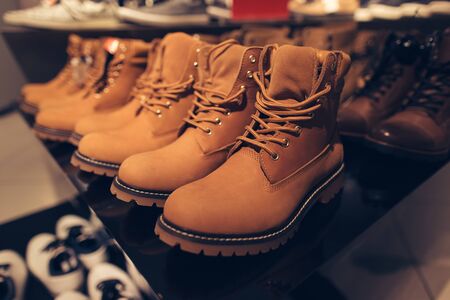 Men's winter boots. Men's winter brown boots in clothing store ready for saleの写真素材