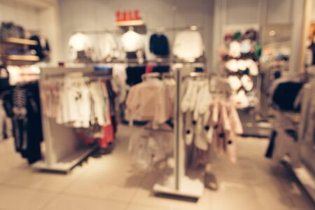 Clothes in store. Shopping clothes store blurred backgroundの写真素材