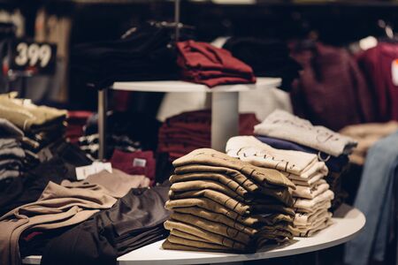 Clothes store. Stack of men clothes in men's clothing storeの写真素材