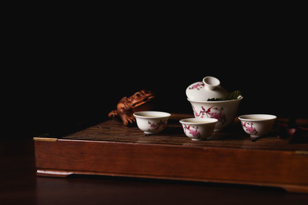 Chinese tea ceremony. Tea set on tea desk chaban with golden frog.  Soft selective focus.