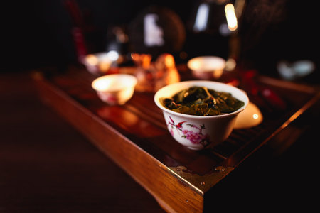 Chinese tea ceremony. Cup of tea on tea desk chaban. Soft selective focus.