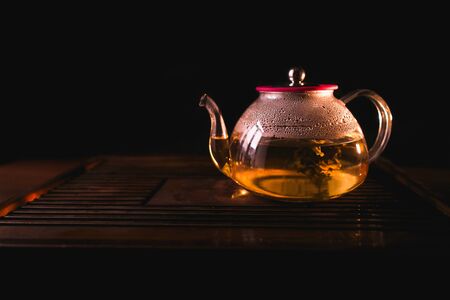 Blooming Tea. Flowering tea in teapot on a tea desk. Chinese tea.の写真素材
