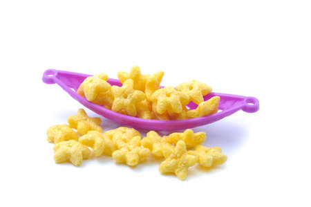 Star shape cereal in the purple basket on white backgroundの写真素材