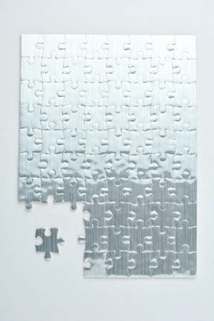 Missing jigsaw puzzle piece red color, business concept for completing the final puzzle pieceの写真素材