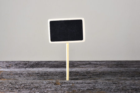 Small blackboard on the rusty wooden tableの写真素材