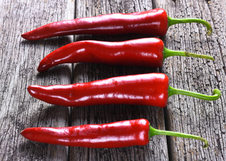 Red chilies on the rusty wooden table