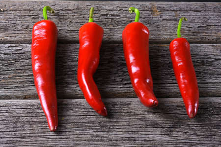 Red chilies on the rusty wooden tableの写真素材