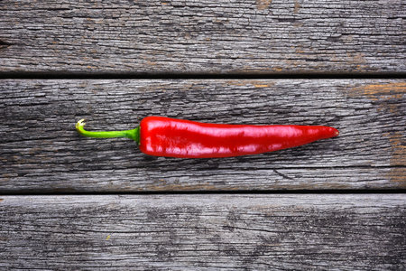 Red chilies on the rusty wooden table