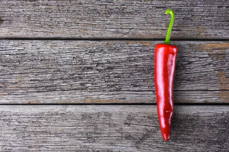 Red chilies on the rusty wooden tableの写真素材
