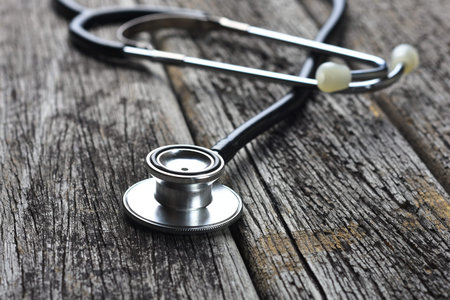 Stethoscope on wooden tableの写真素材