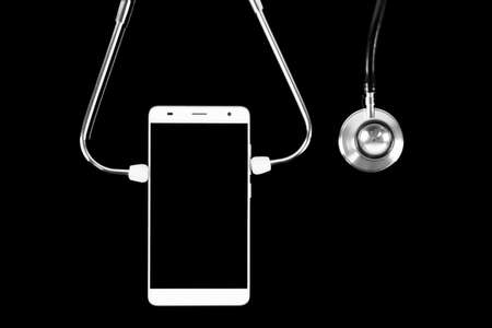Stethoscope and smartphone on black backgroundの写真素材