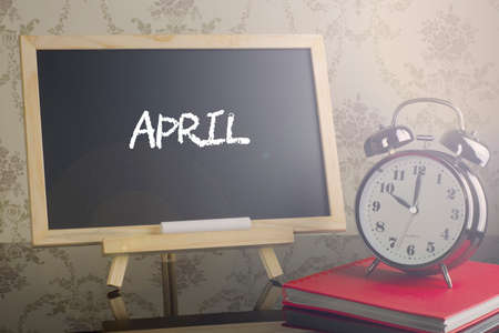 APRIL on chalkboard with alarm clock.の写真素材