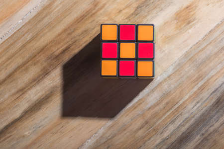 KUALA LUMPUR, MALAYSIA - SEPTEMBER 17, 2017: Rubik's 3x3x3 classic cube on wooden table. Rubik's Cube invented by a Hungarian architect Erno Rubik in 1974.のeditorial素材