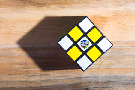 KUALA LUMPUR, MALAYSIA - SEPTEMBER 17, 2017: Rubik's 3x3x3 classic cube on wooden table. Rubik's Cube invented by a Hungarian architect Erno Rubik in 1974.のeditorial素材
