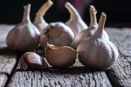 Organic garlic whole and cloves on the wooden backgroundの写真素材