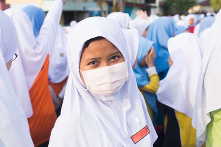 Girl with face mask at cross country strating lineのeditorial素材