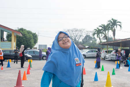 KUALA LUMPUR, MALAYSIA - JANUARY 20, 2018: Group of primary school athletes running a cross country raceのeditorial素材