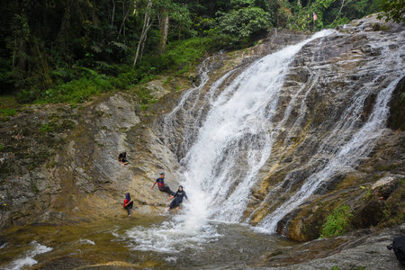 Lata Iskandar, Perak, Malaysia. March 25, 2018. A lady taking a rest at a Lata Iskandar waterfall,...