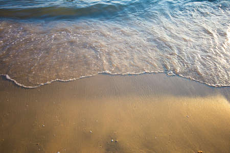Wave of the sea on the sand beach, summer sand beach background.の写真素材