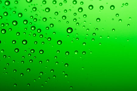 Drops of water on a color background. Green tone