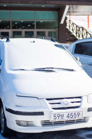 SEOUL, SOUTH KOREA - DECEMBER 10, 2018: Vehicles are parked on the street and covered with large amount of snowのeditorial素材