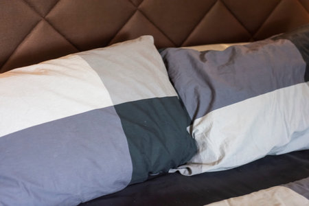 Natural soft pillows on comfortable bed at homeの写真素材