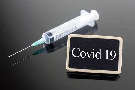 Medical Concept-Covid 19 word written on blackboardの写真素材