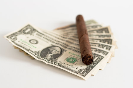 Bunch of dollars with cigar on topの写真素材