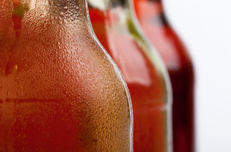 A closeup shot of three cool bottles of fresh beveragesの写真素材