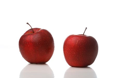 Two red apples with waterdrops isolated on white backgroundの写真素材