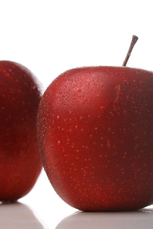 A red apple with waterdrops isolated on white background